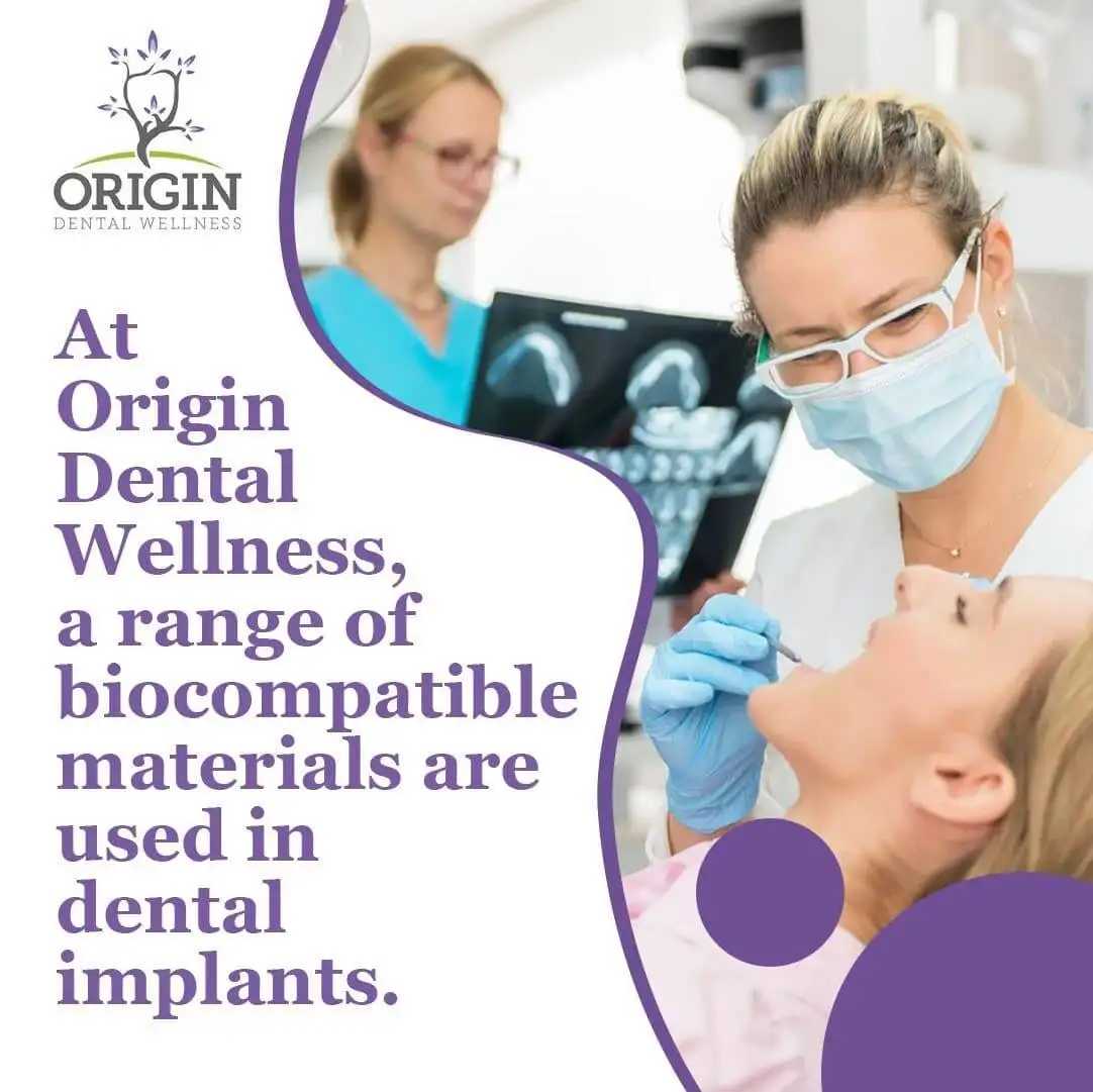 A dentist in a mask and gloves examining a patient's mouth, with another dental professional in the background reviewing dental X-rays.