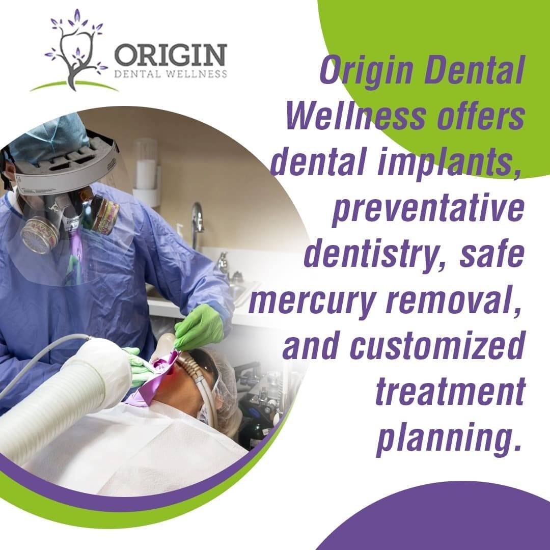 A dental professional in protective gear performs a dental procedure on a patient, with text overlay describing Origin Dental Wellness services like implants, preventative dentistry, and mercury removal.